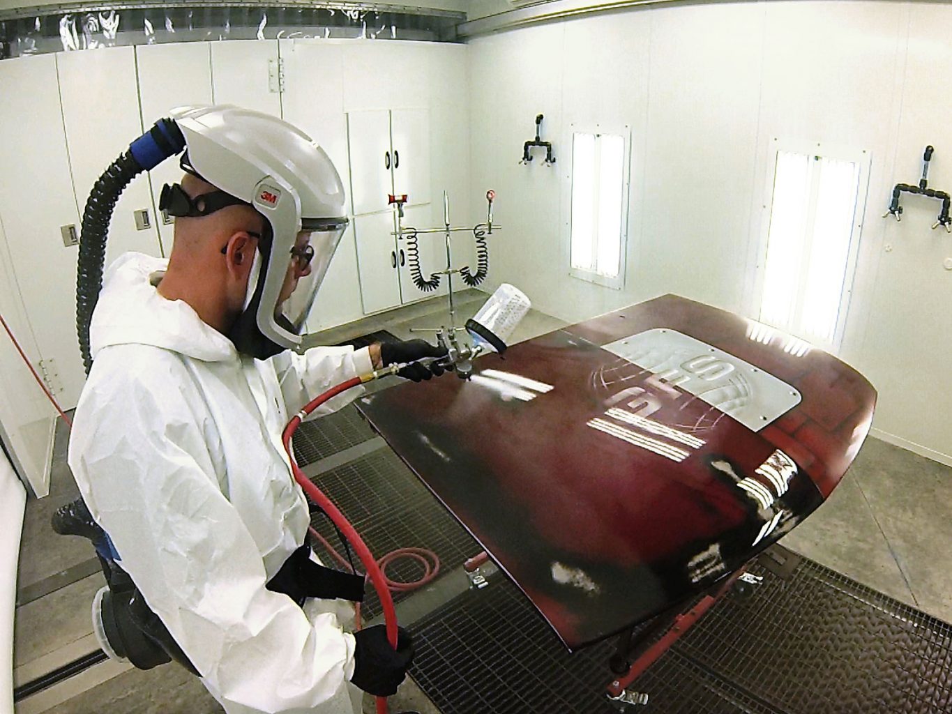 Painter Painting in spray booth