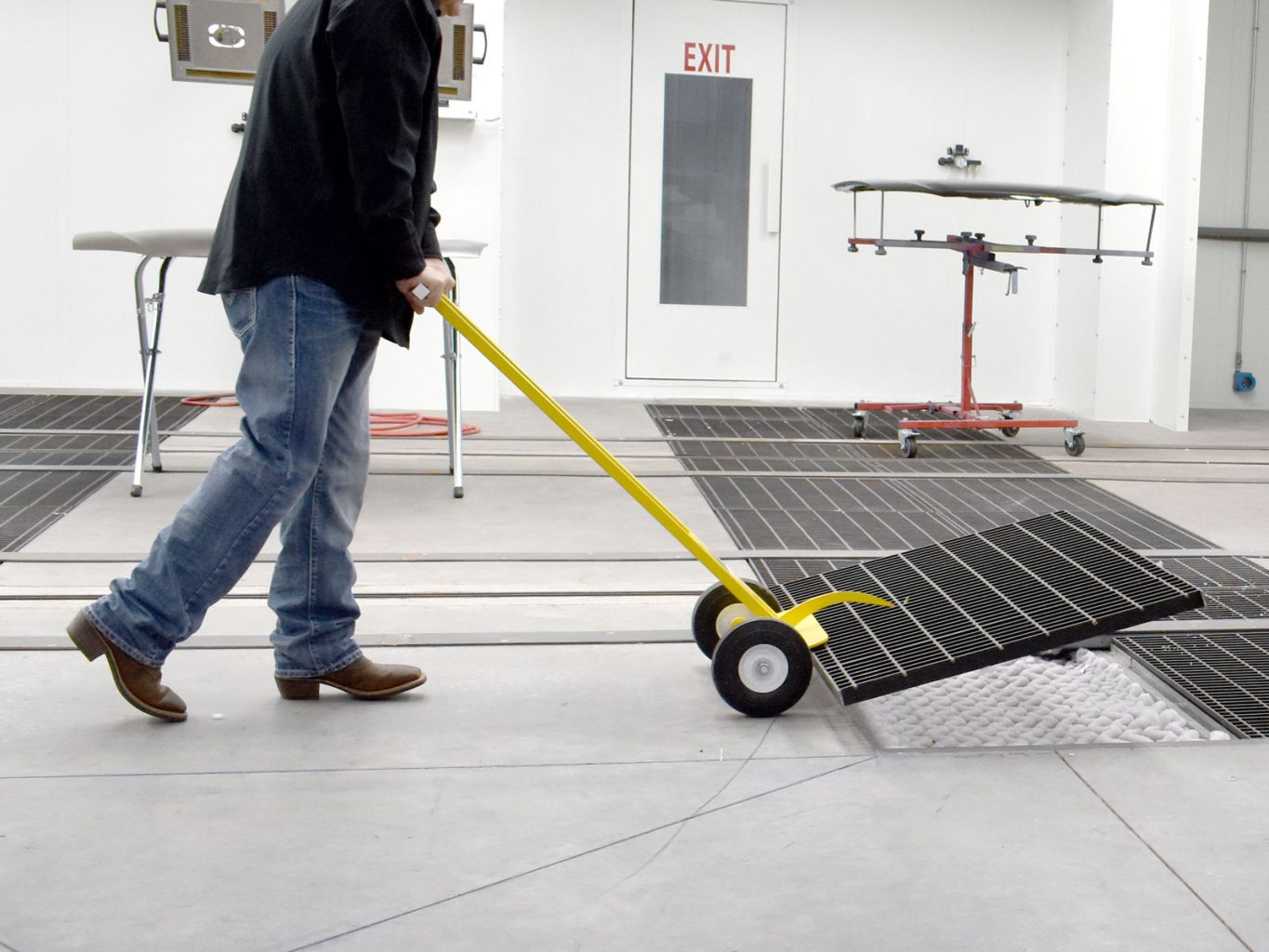 GFS Technician placing floor grating with lift tool